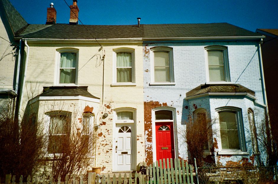 Row of painted houses with red and white doors