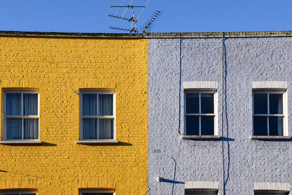 Yellow and blue painted houses side by side