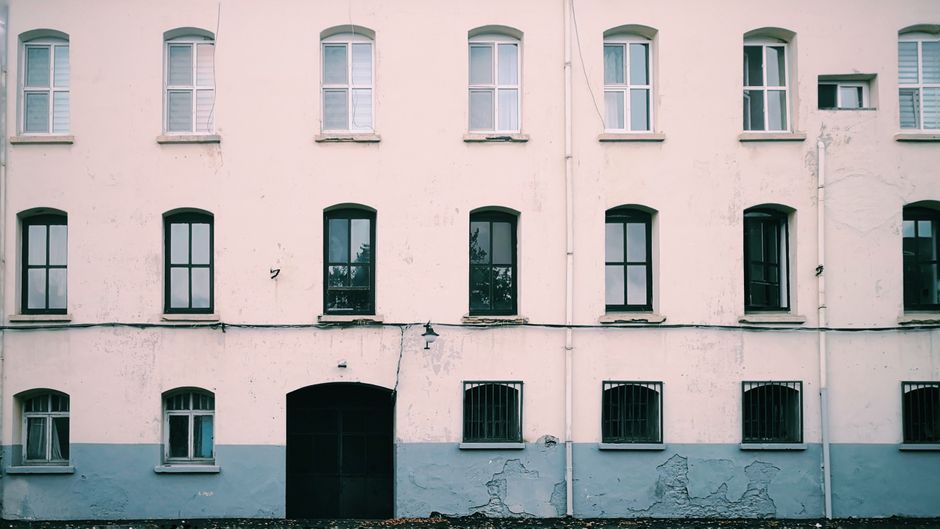 Painted building front with evenly spaced windows
